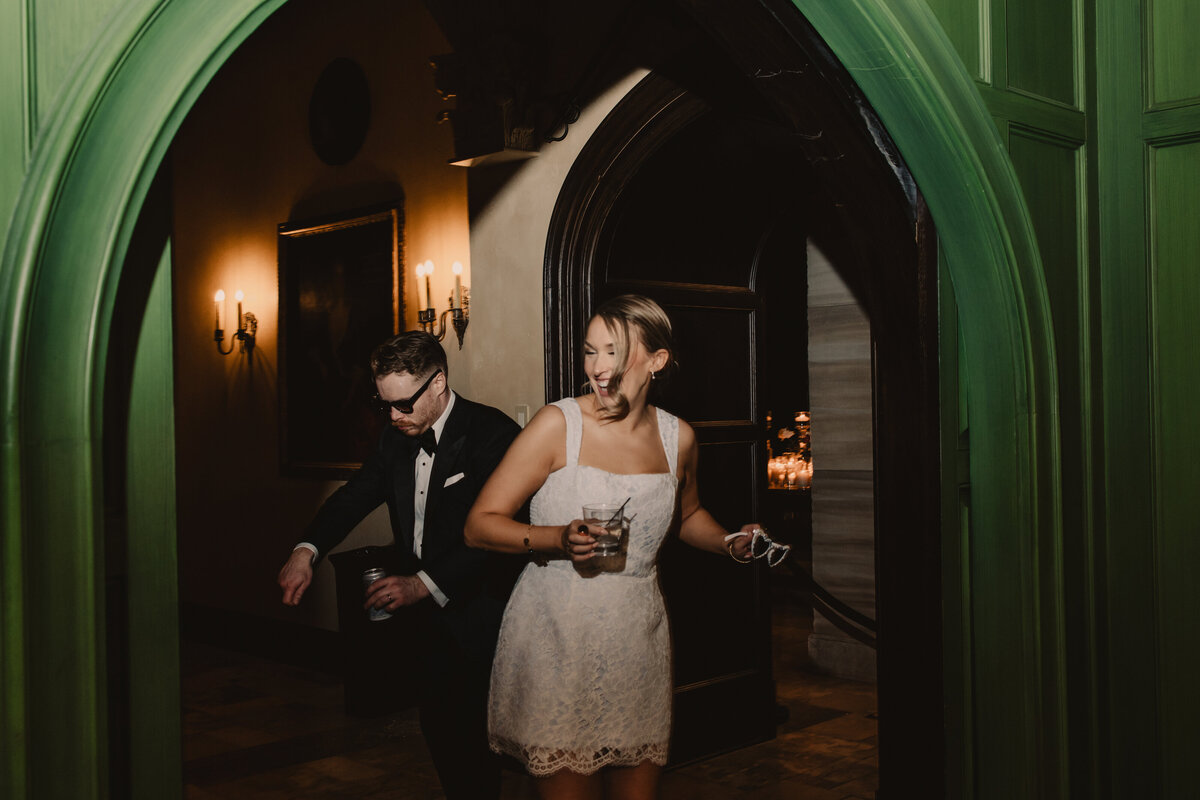 A wedding couple dancing together in a hallway 