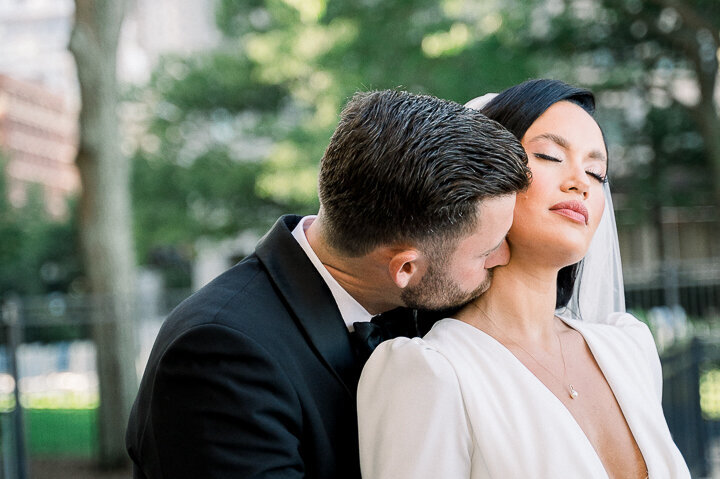 groom kissing bride on the neck