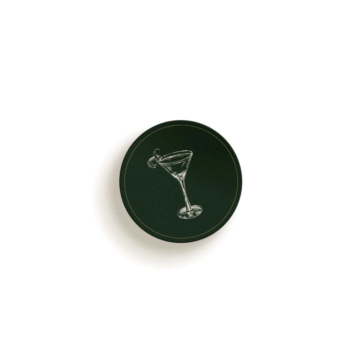 A circular dark green coaster featuring an illustration of a martini glass with a garnish, perfect for any branding designer's desk.