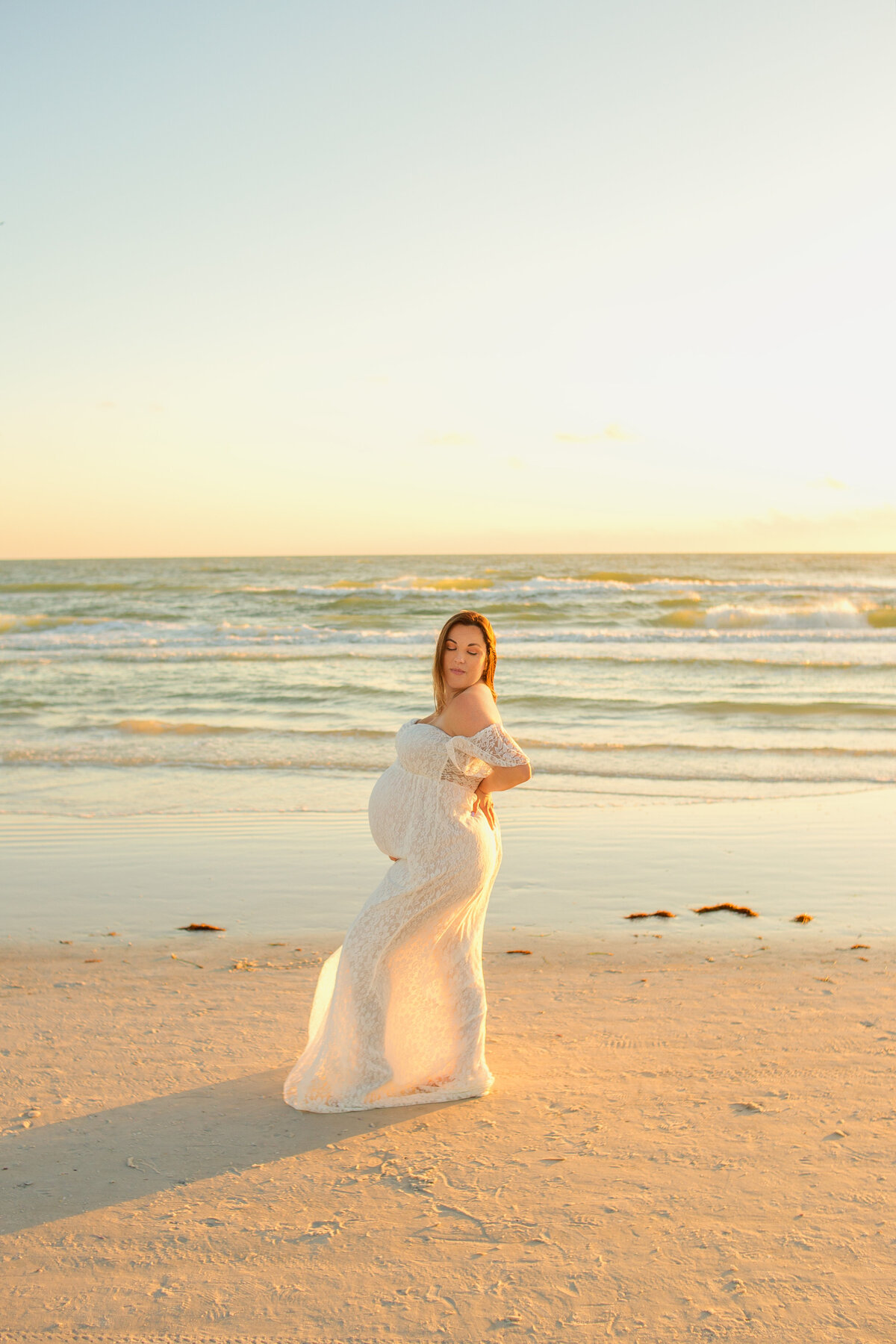 Pregnant women wearing white gown during maternity photoshoot with Franklin tennessee photographer