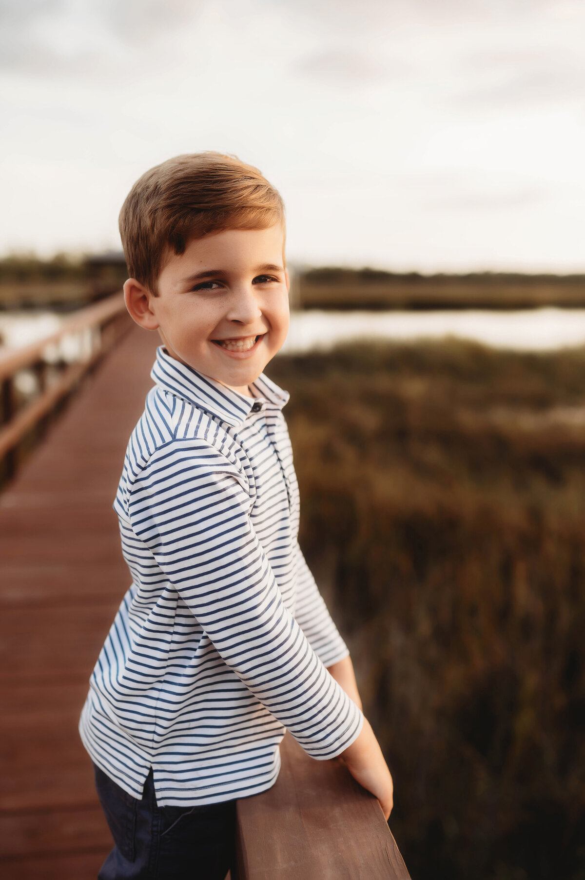 Little boy smiles at the camera during Family Photos in Charleston.