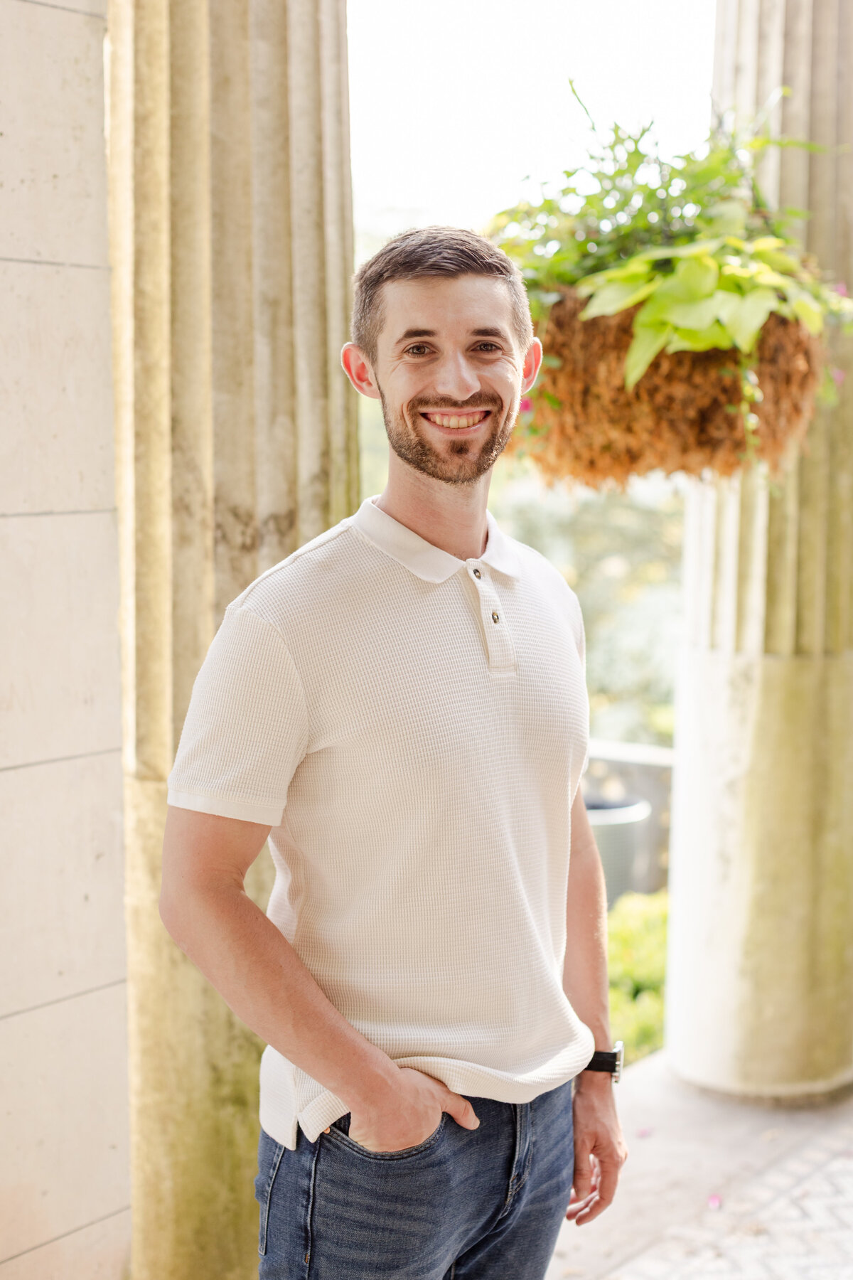 man-smiling-during-Yonkers-garden-engagment-session