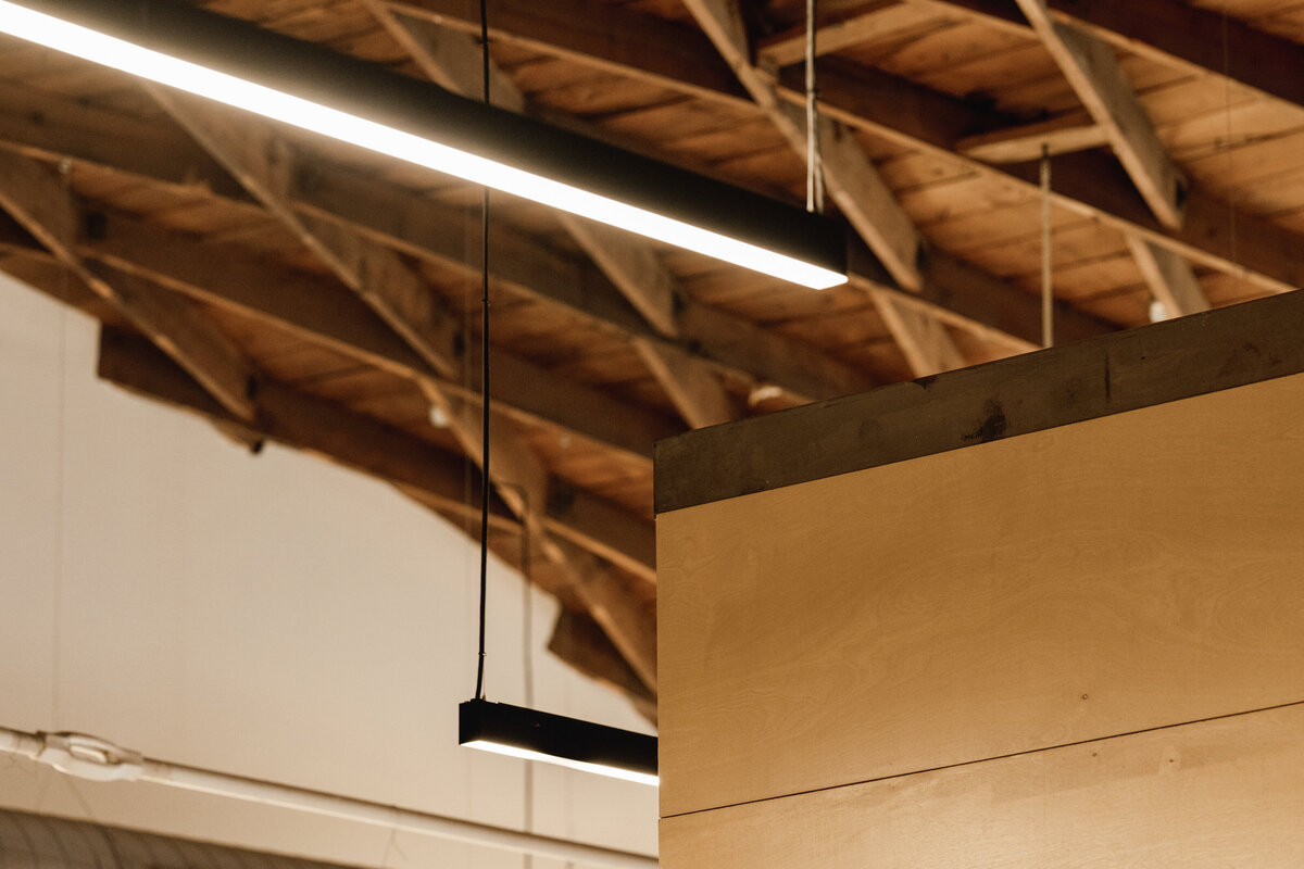 renovated office building with wood ceiling and linear light fixtures