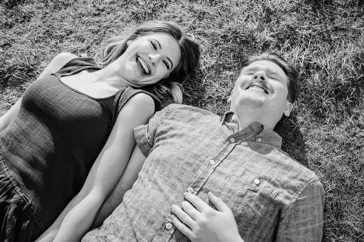 Missoula couple laying on grass and laughing