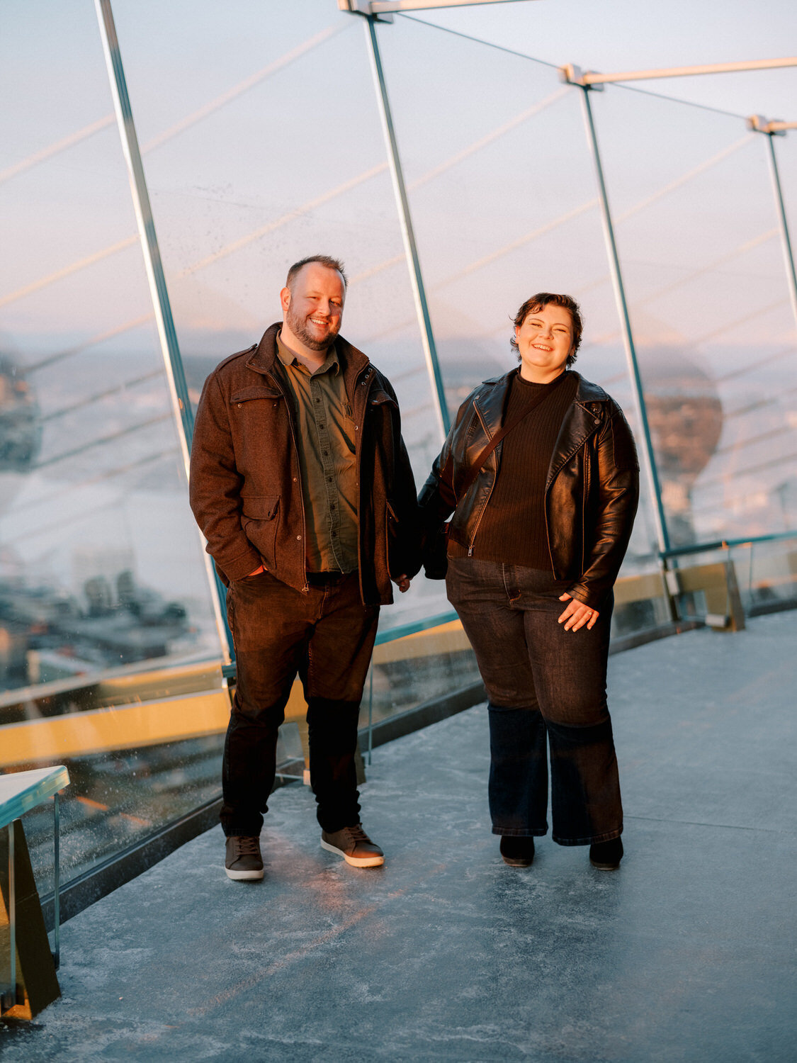 Couple holds hands on top of the space needle