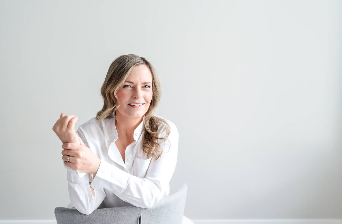 personal branding headshot of woman in white against white background