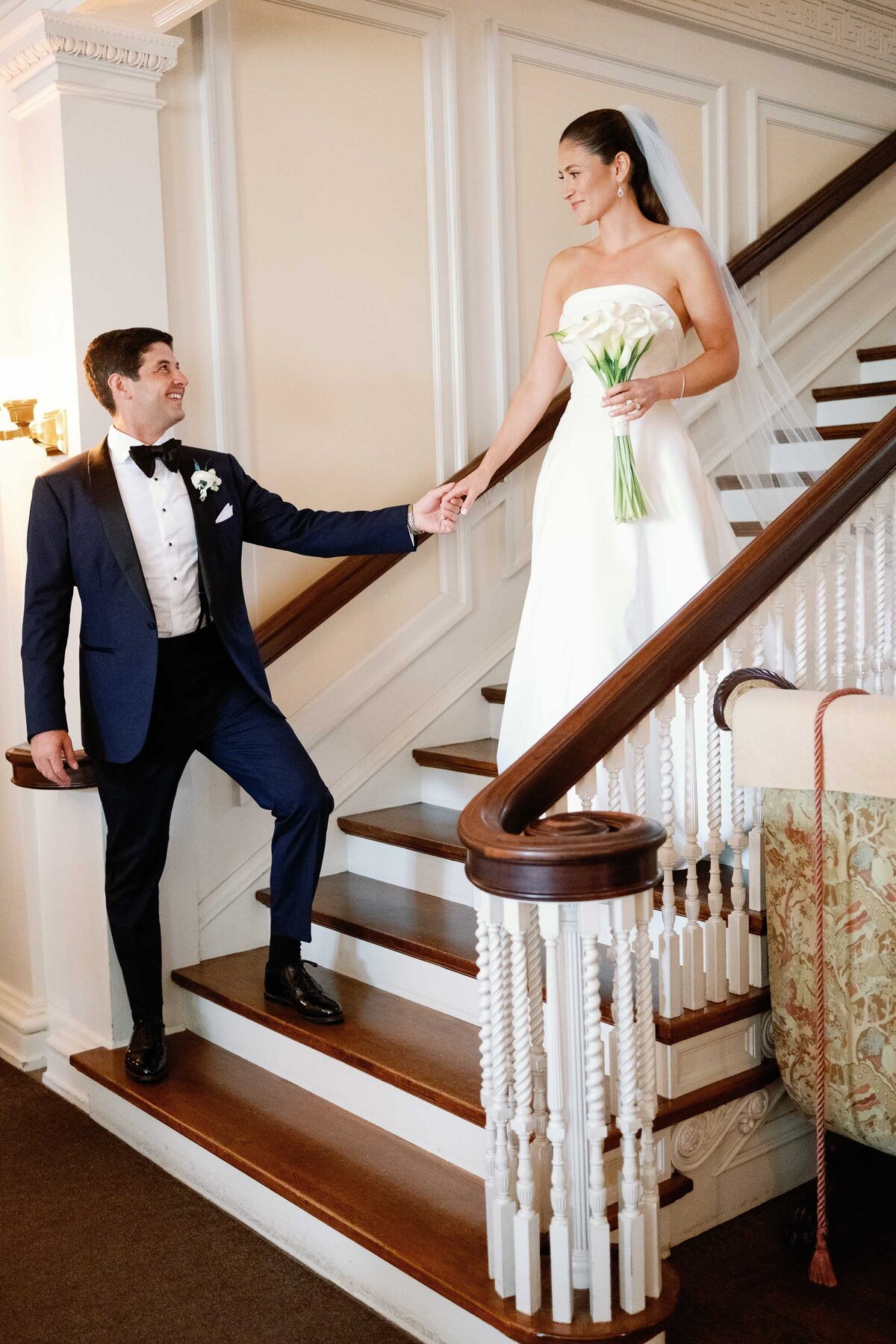 bride and groom descend staircase at hildene wedding in manchster, vt