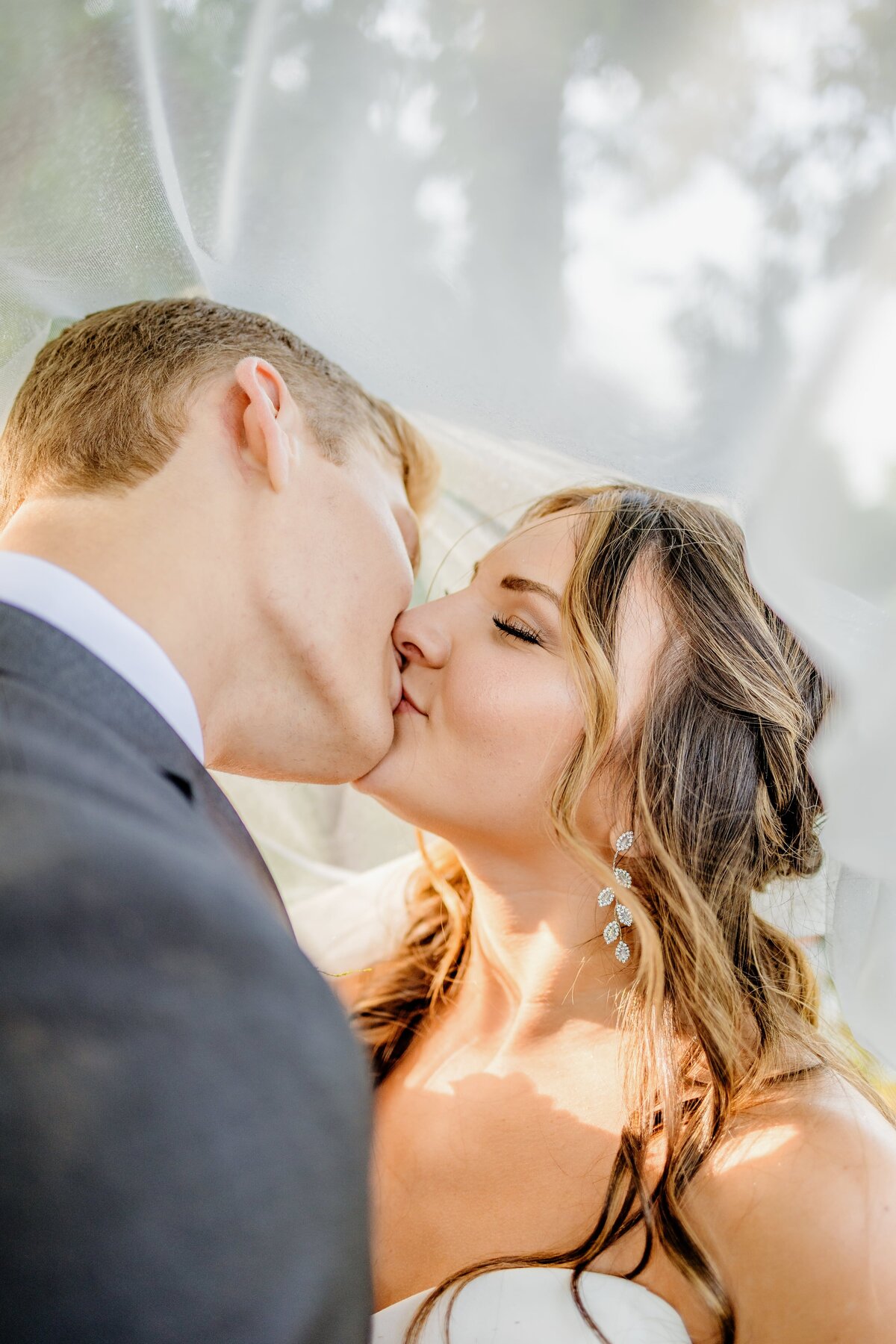 Bride and groom kiss on wedding day