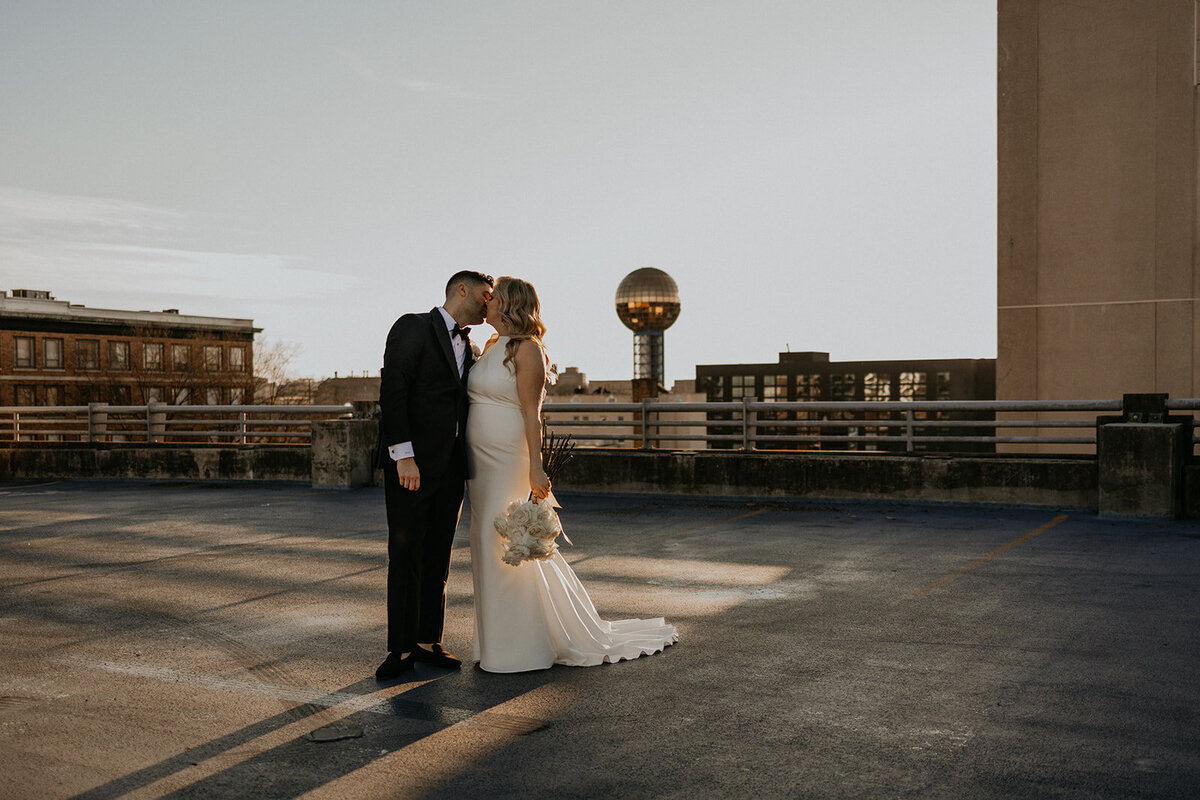 bride and groom in downtown Knoxville with the Sunsphere in the back