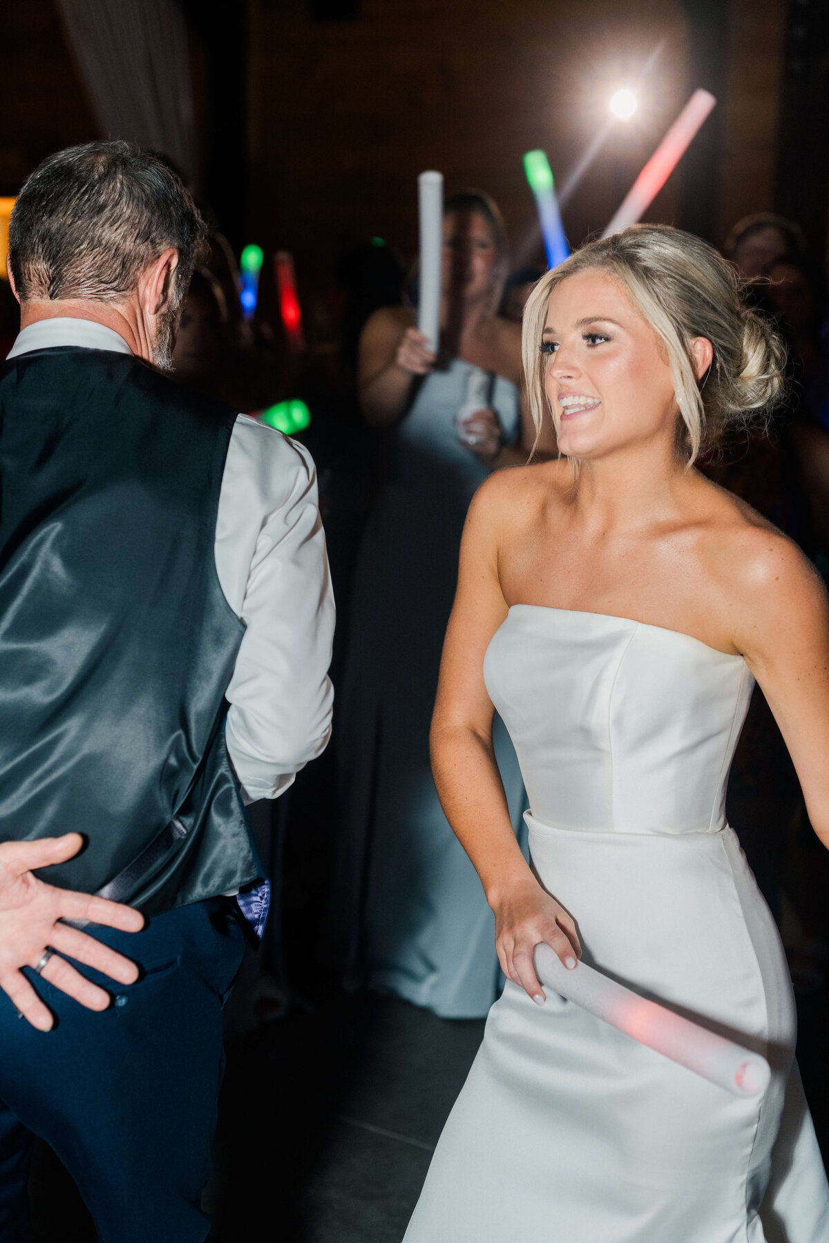 Bride dancing during reception with light wand
