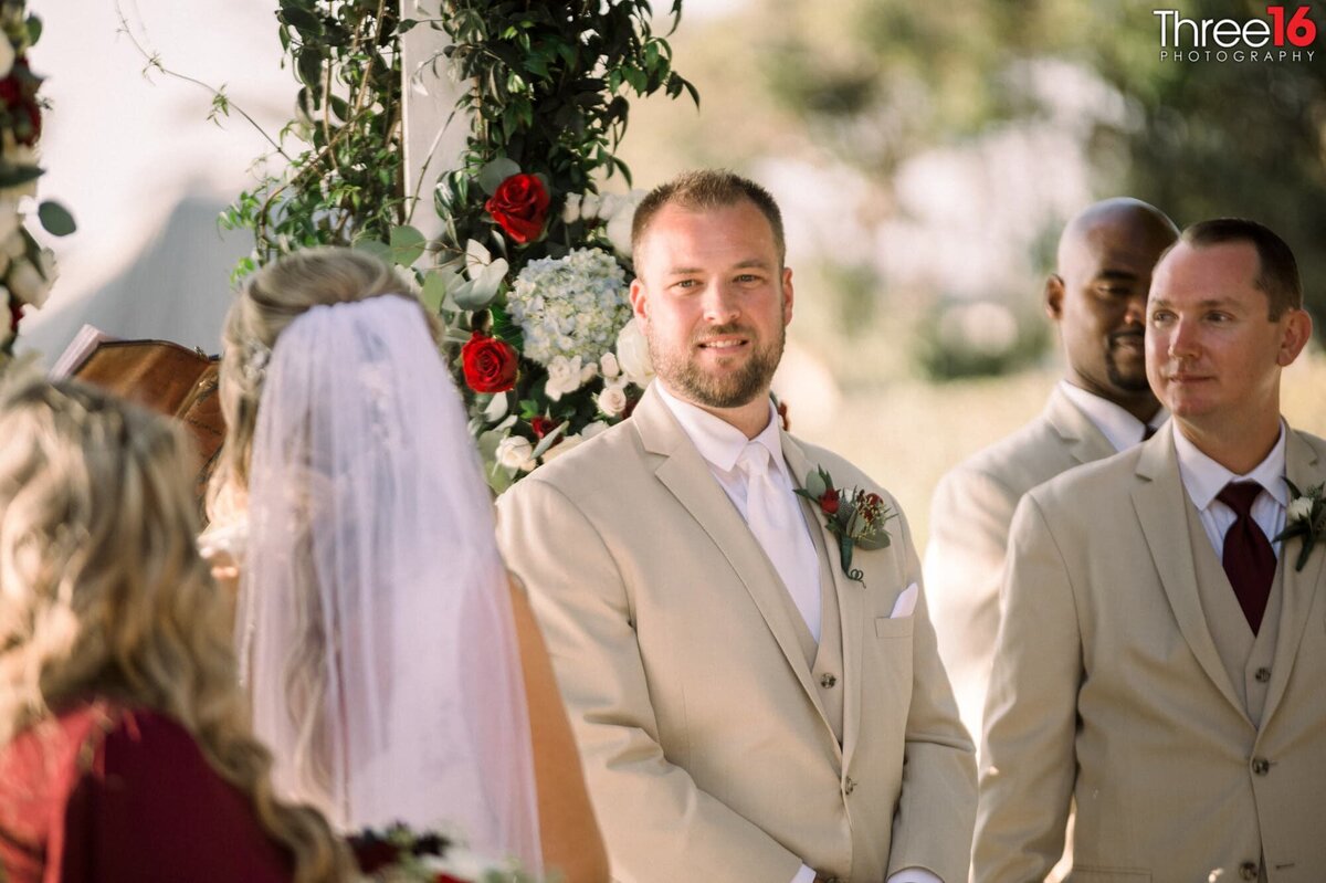 Groom gazes at his Bride after she arrives at the altar