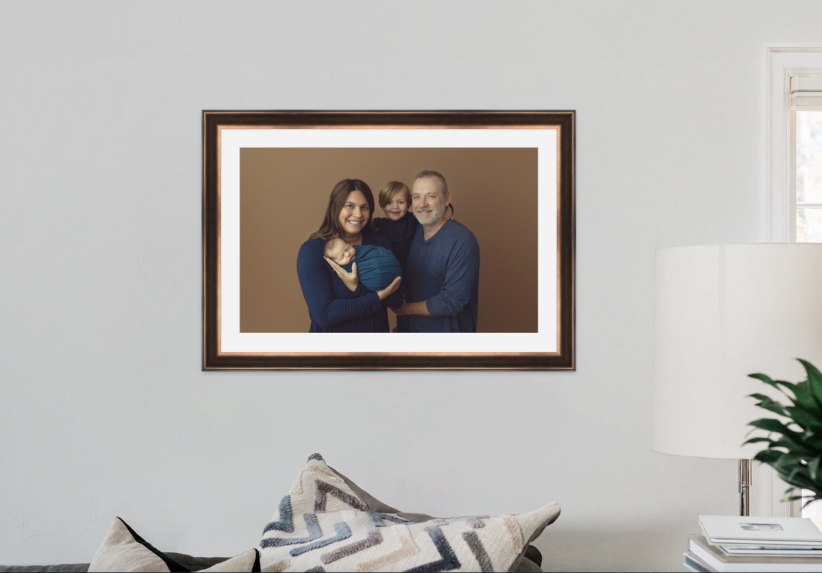 Newborn family photograph hanging on the wall.