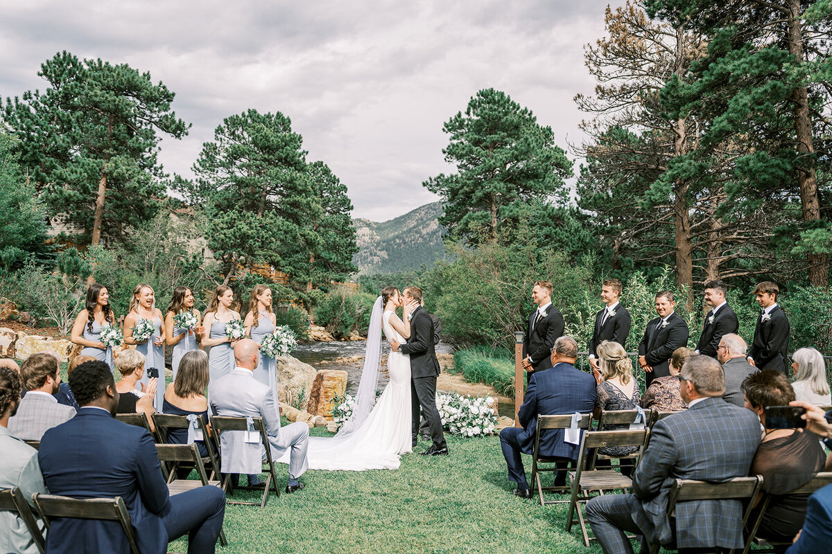 Bride and Groom share their first kiss during their wedding ceremony at the Landing in Estes Park.