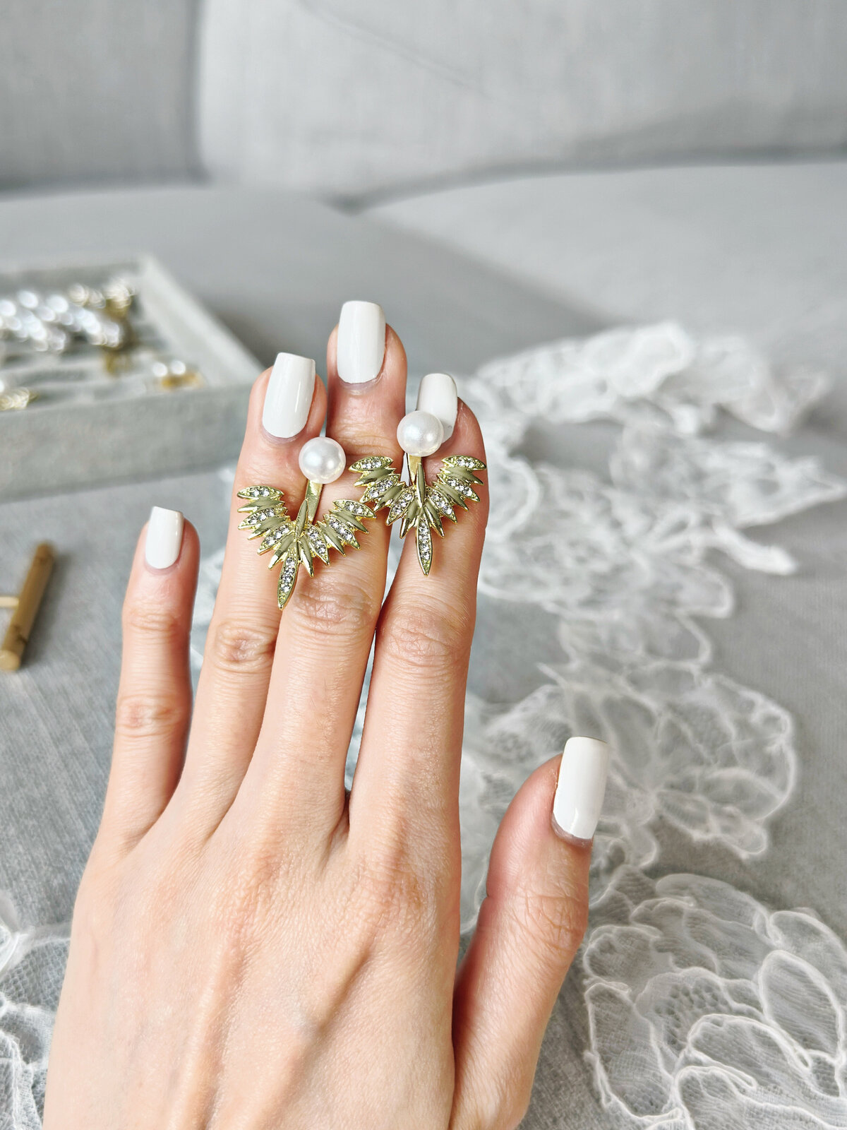 Timeless pearl stud earrings framed with delicate crystals
