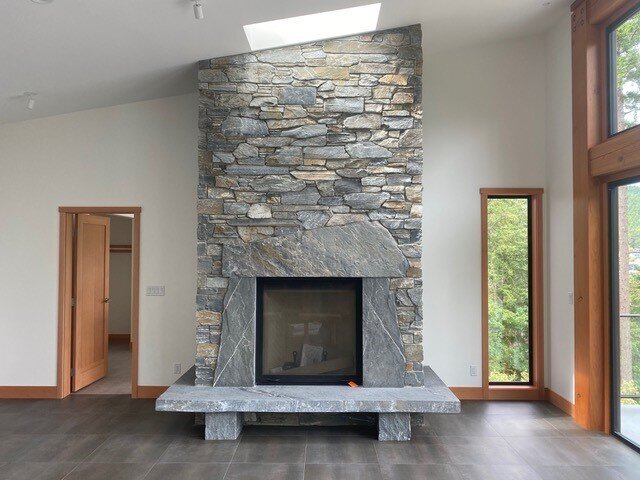 Floor to ceiling stone fireplace.