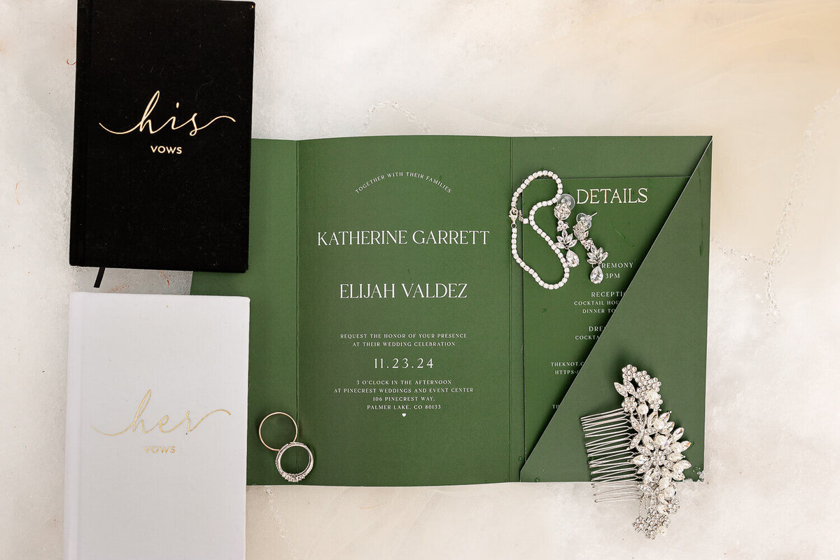 wedding details in thee snow with hair jewelry, bracelet, earings, rings, vows, and invitation. Photography by Michelle Colorado and Wedding photographer