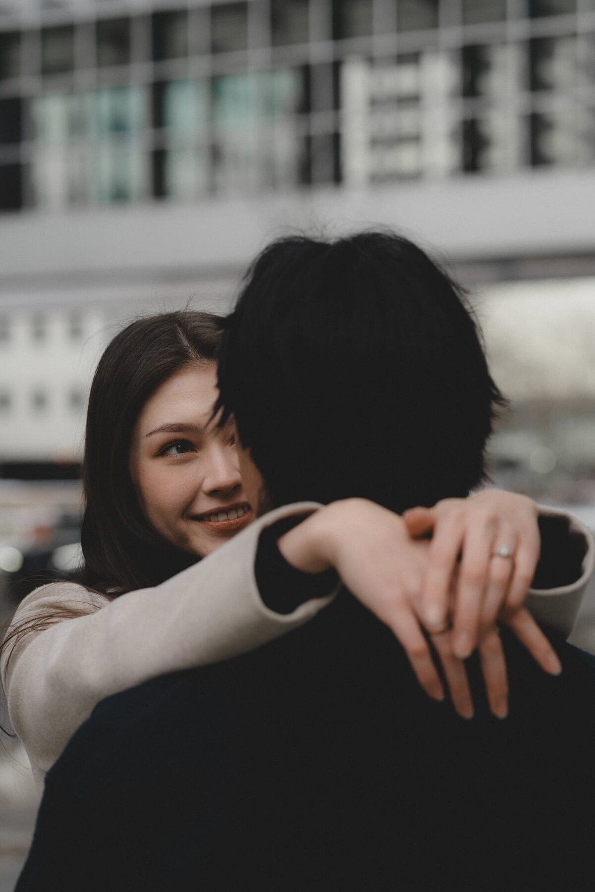 Engaged couple look into each other's eyes in downtown Calgary, Alberta