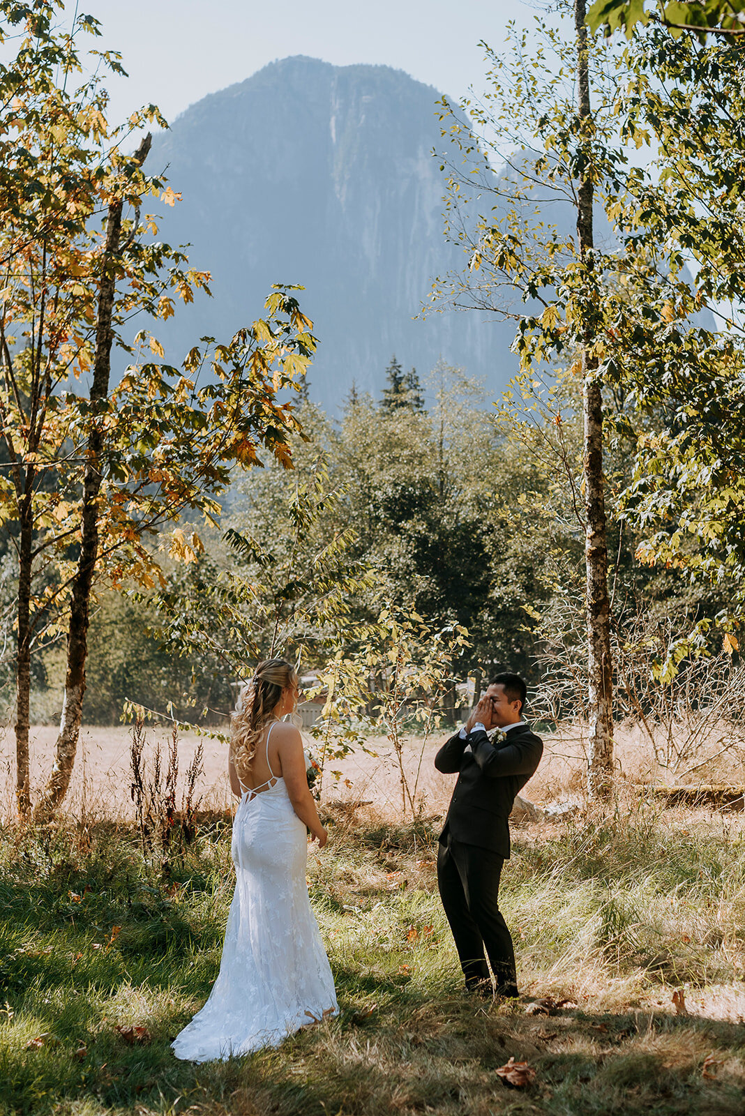 Squamish couple shares first look before their backyard wedding ceremony in the shadow of the Squamish Cheif