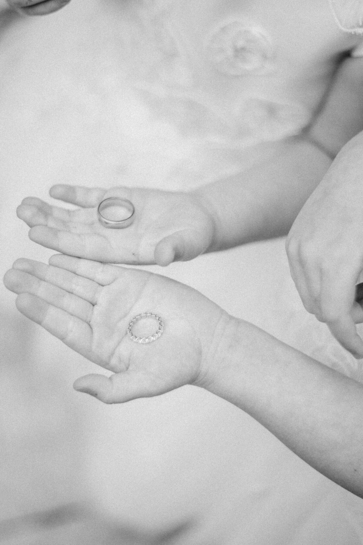 Flower girls holding wedding bands excited to give to bride and groom
