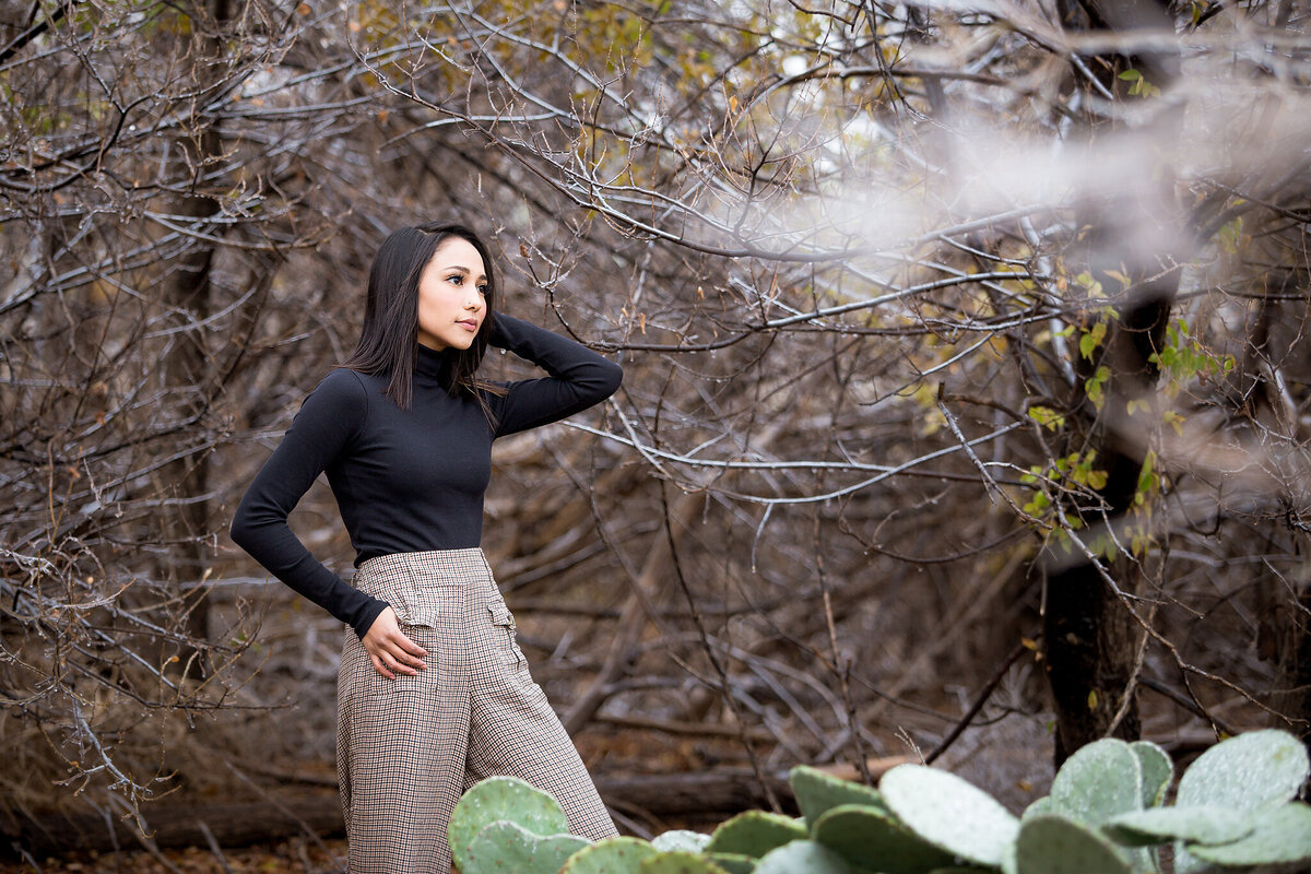 Senior girl standing next to frozen cactus