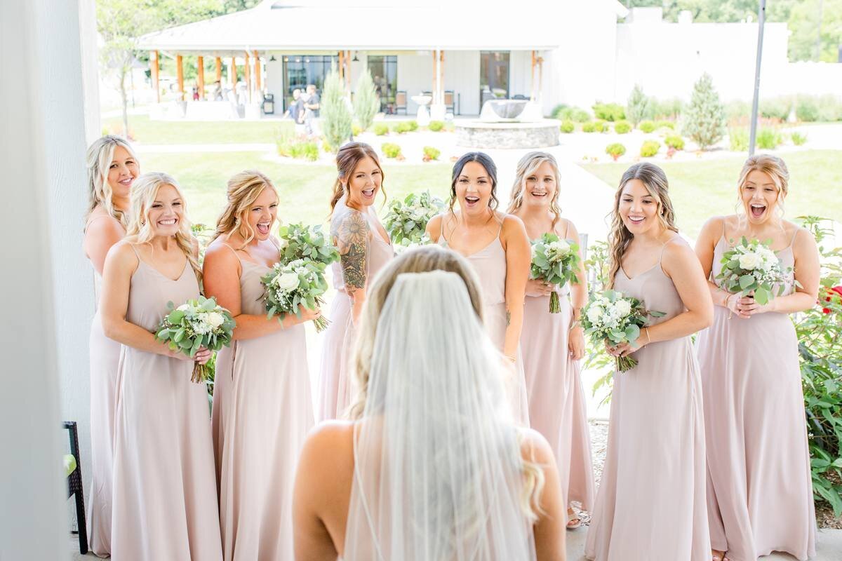 bridesmaids react to seeing bride for the first time fully dressed