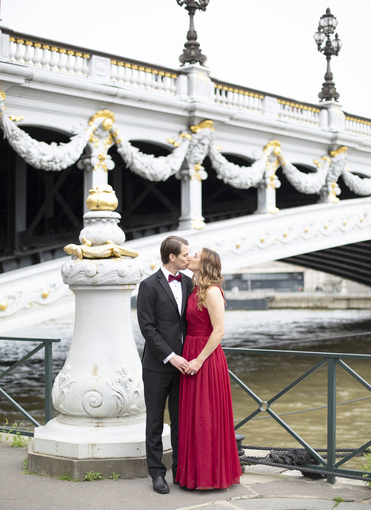 Elegant couple poses for photo on bridge in Paris 60