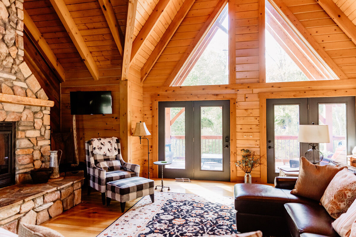 Living area with vaulted wooden ceilings and large windows