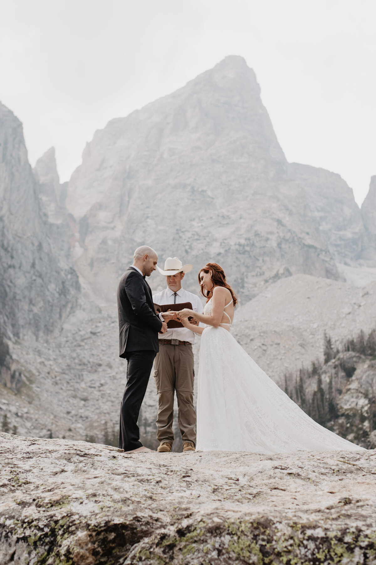 Jackson Hole photographers capture bride putting ring on groom