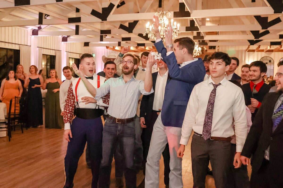 men wait for boutonerre toss at Milestone Georgetown wedding