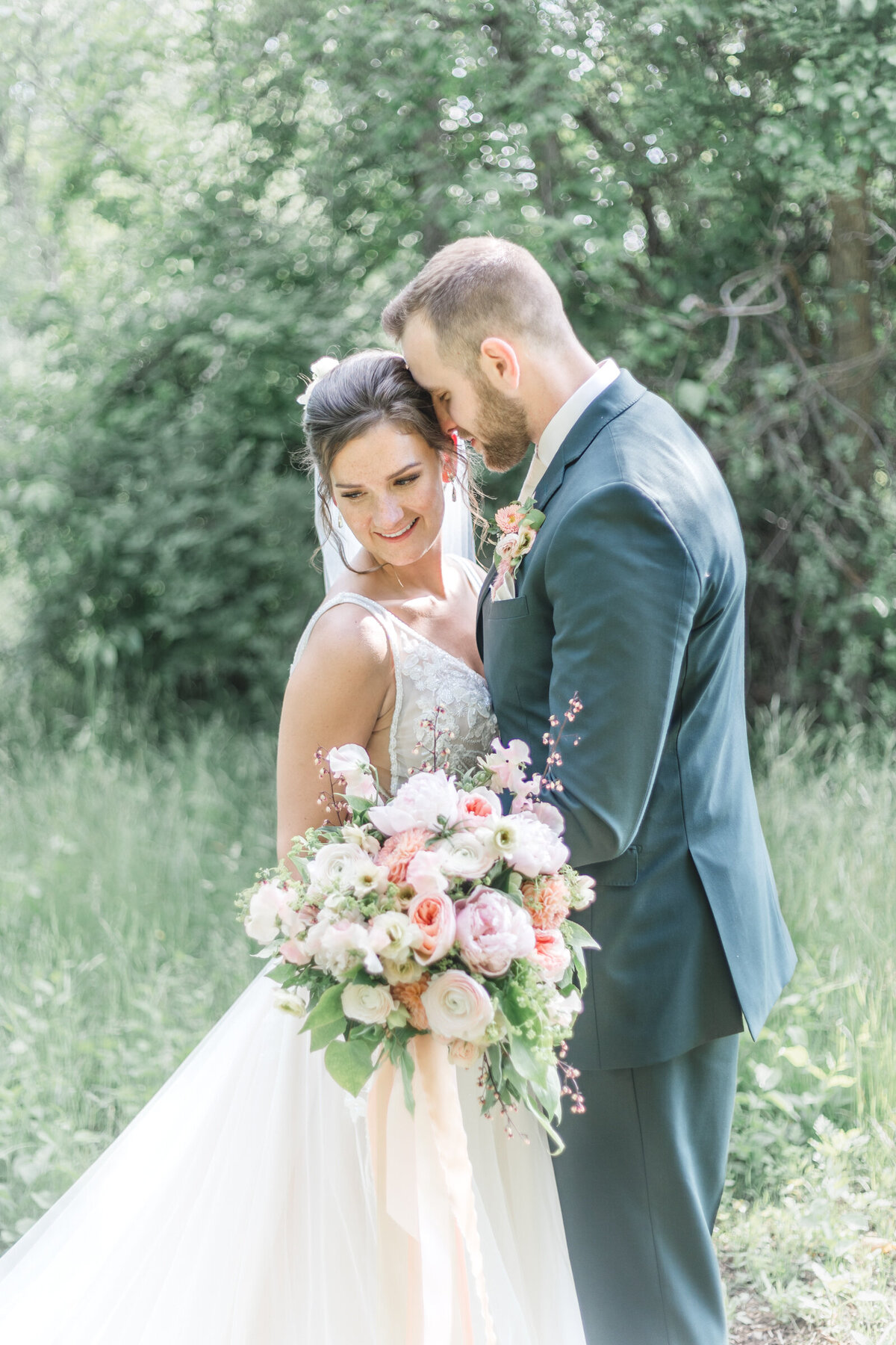 Married couple share a quiet moment alone in a field after their wedding