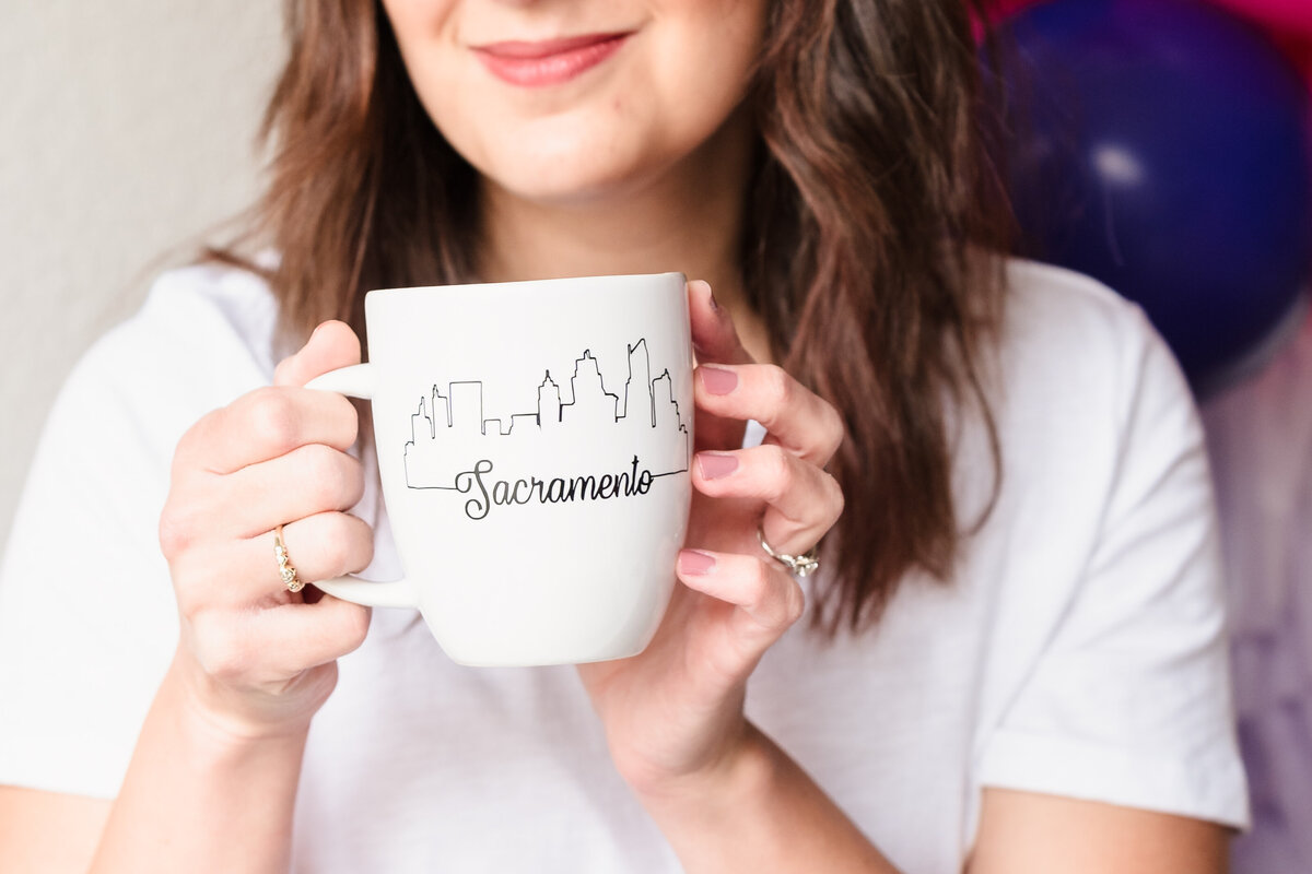 woman holding a Sacramento coffee mug