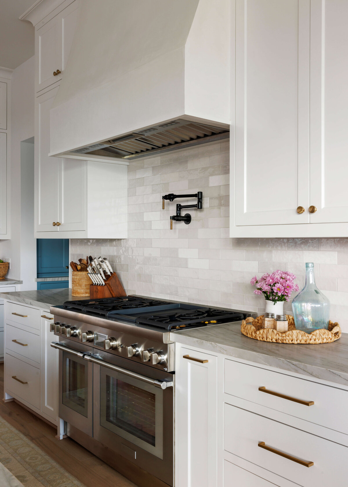 oyster creek studios missouri city new build double steel oven with gray tiled wall and white cabinets with marble counters in kitchen