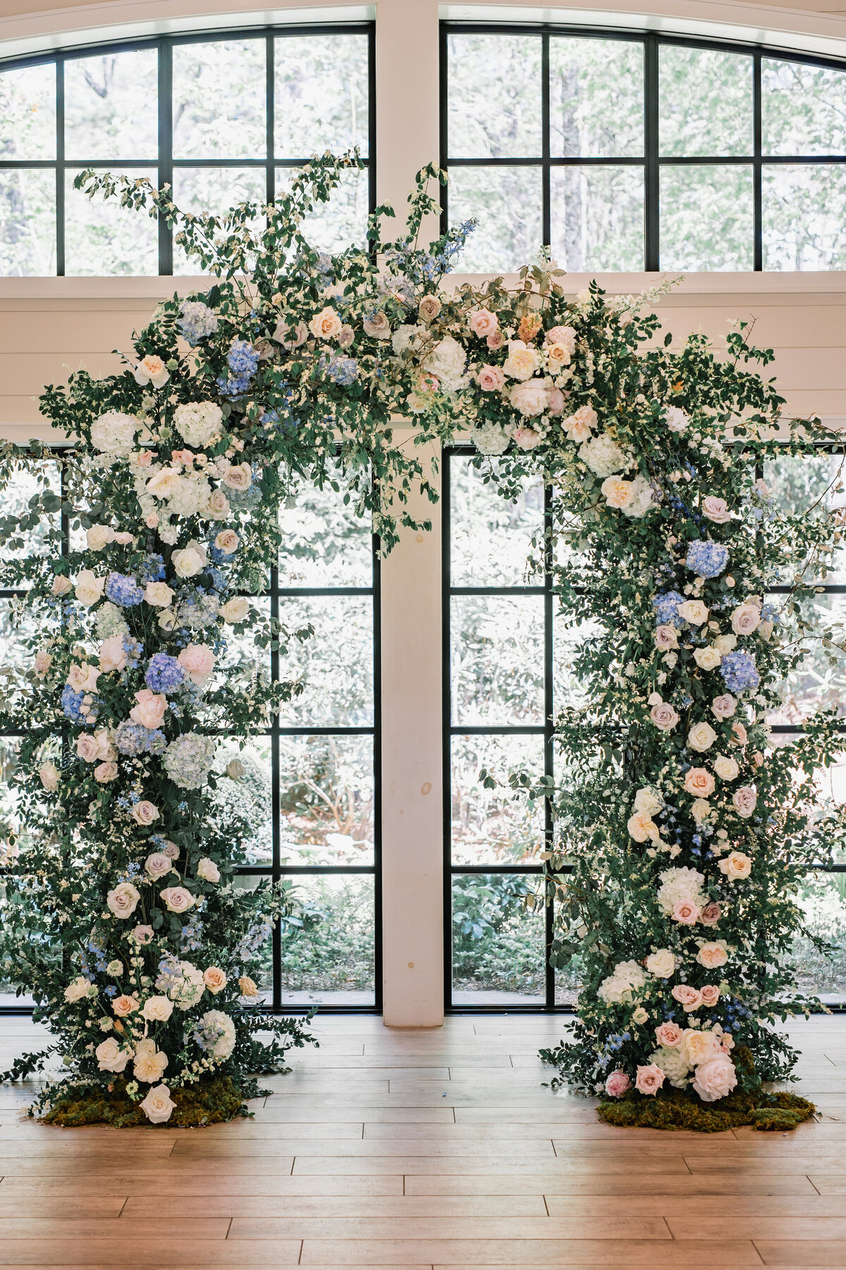 Luxurious floral ceremony arch with roses and hydrangeas at Old Edwards Inn wedding in Highlands, North Carolina.