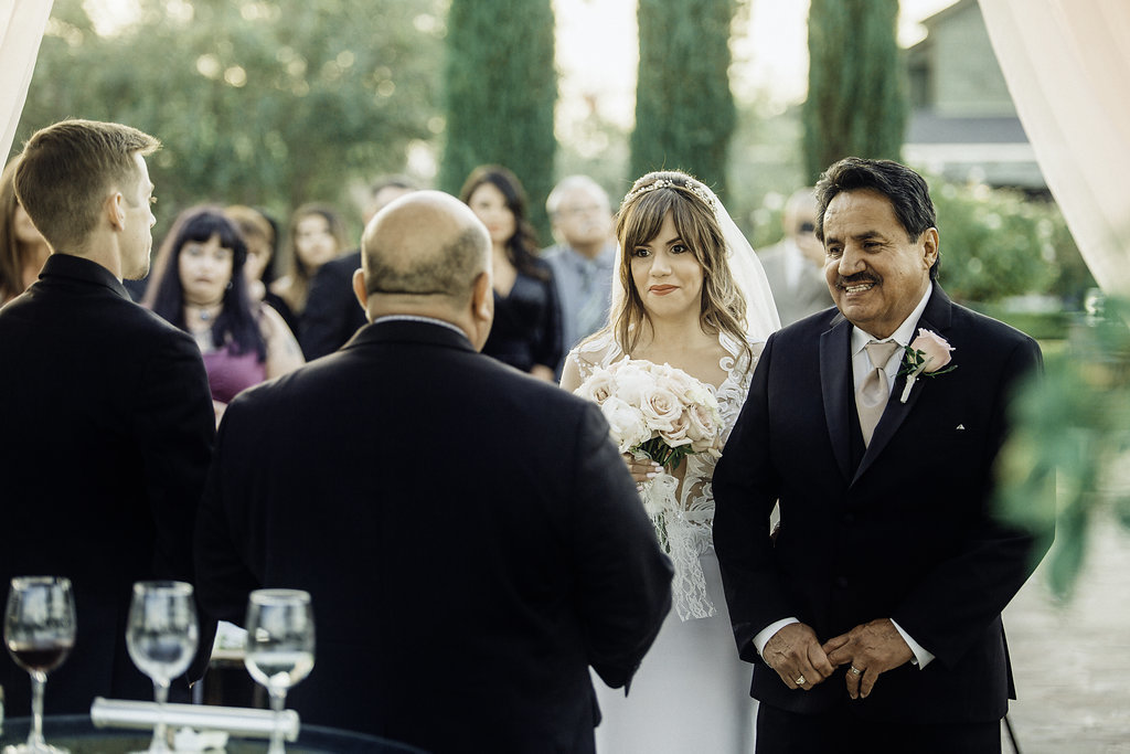 Wedding Photograph Of Three Men in Black Suit And Bride in White Dress Los Angeles