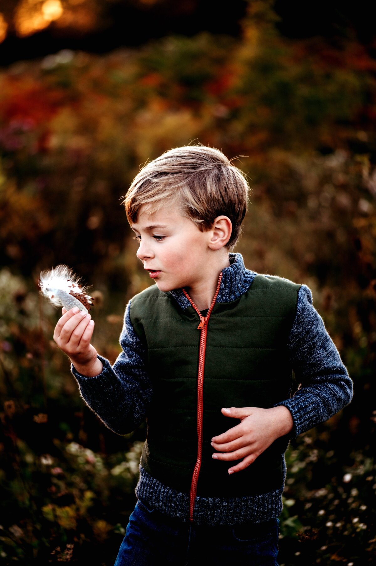 Child blowing milkweed McKennaPattersonPhotography