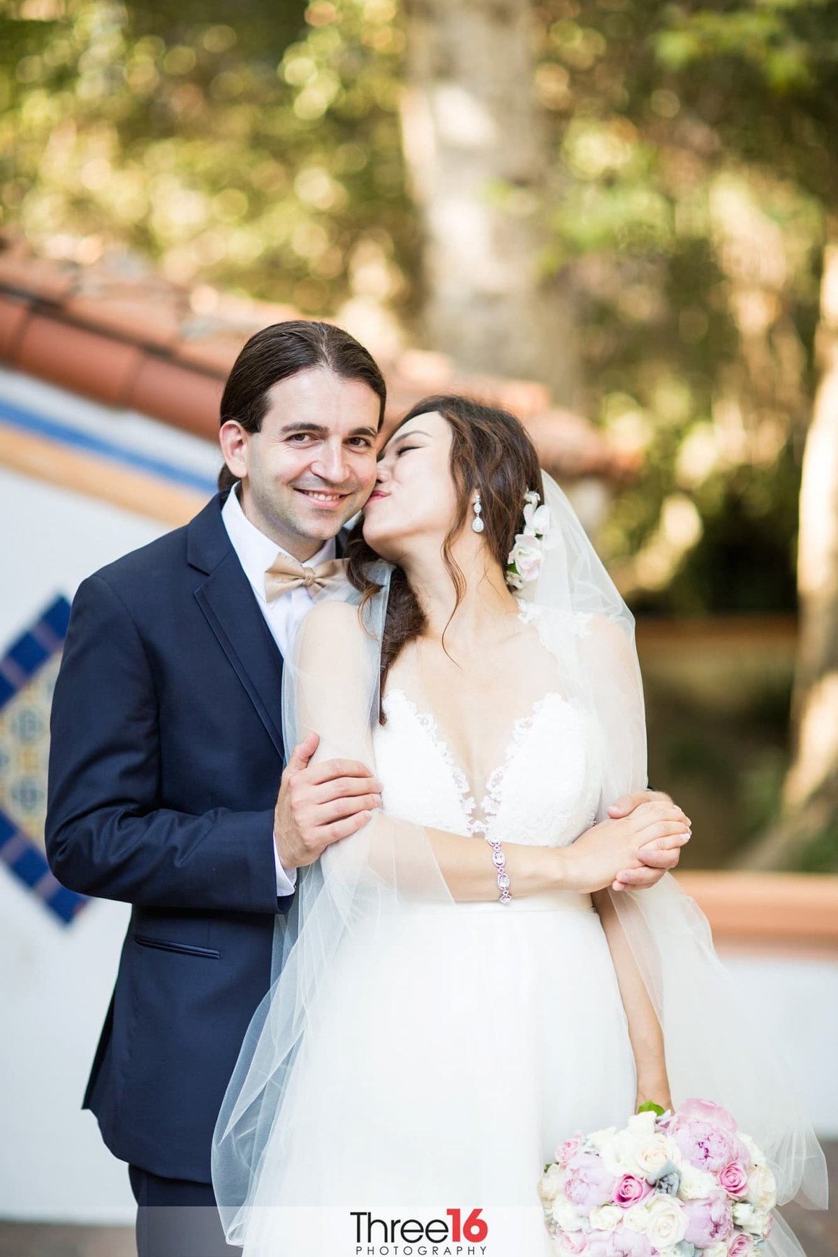 Bride kisses her Groom on the cheek