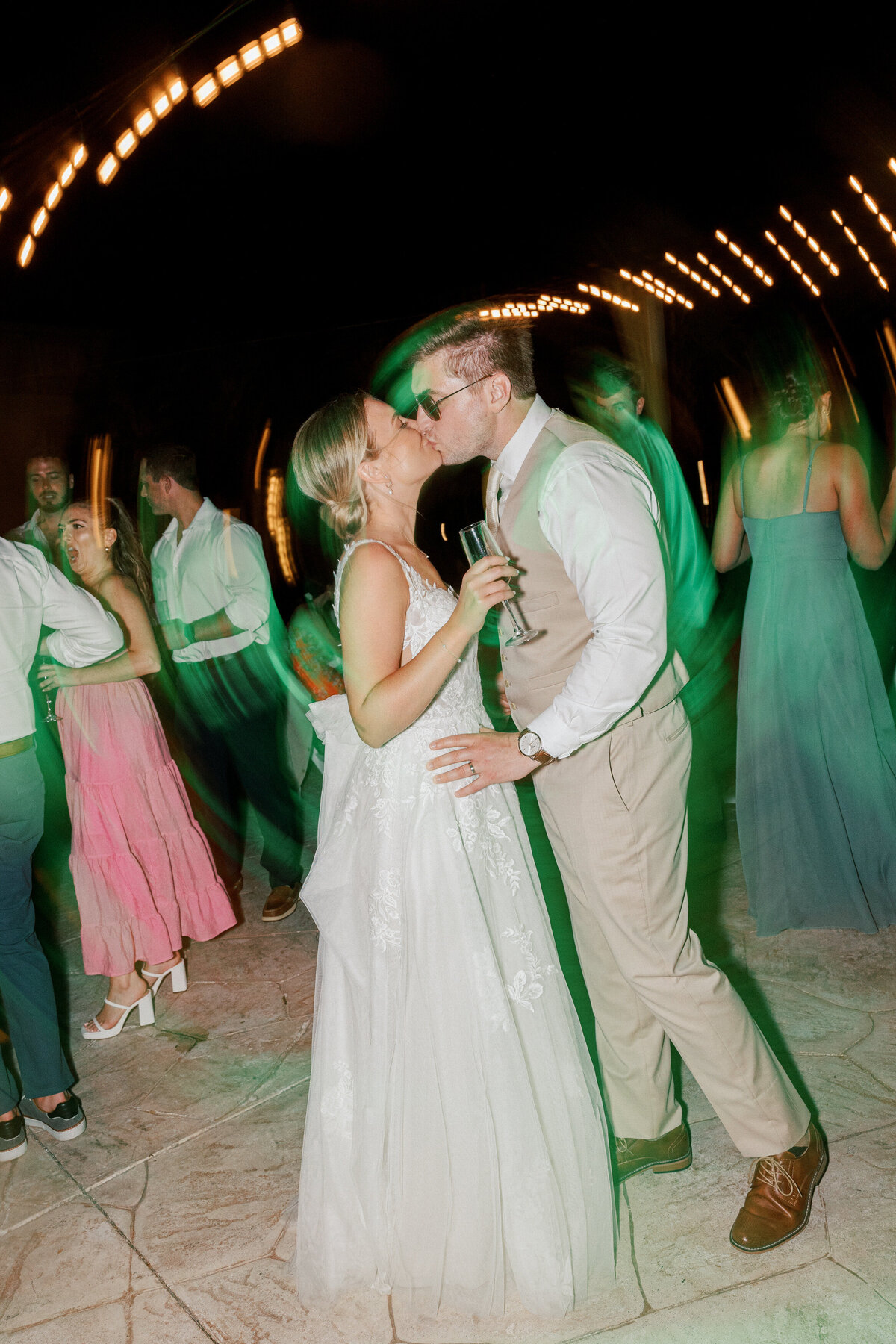 Bride and groom kiss on the dance floor at their Cancun wedding, photographed by a Philadelphia-based photographer.