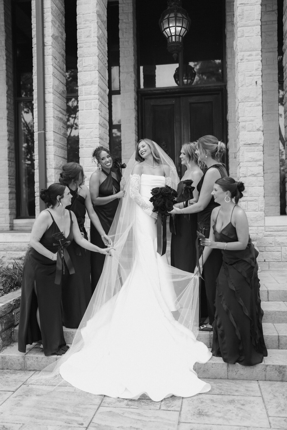 Elegant black and white wedding party bridal portraits on stone steps