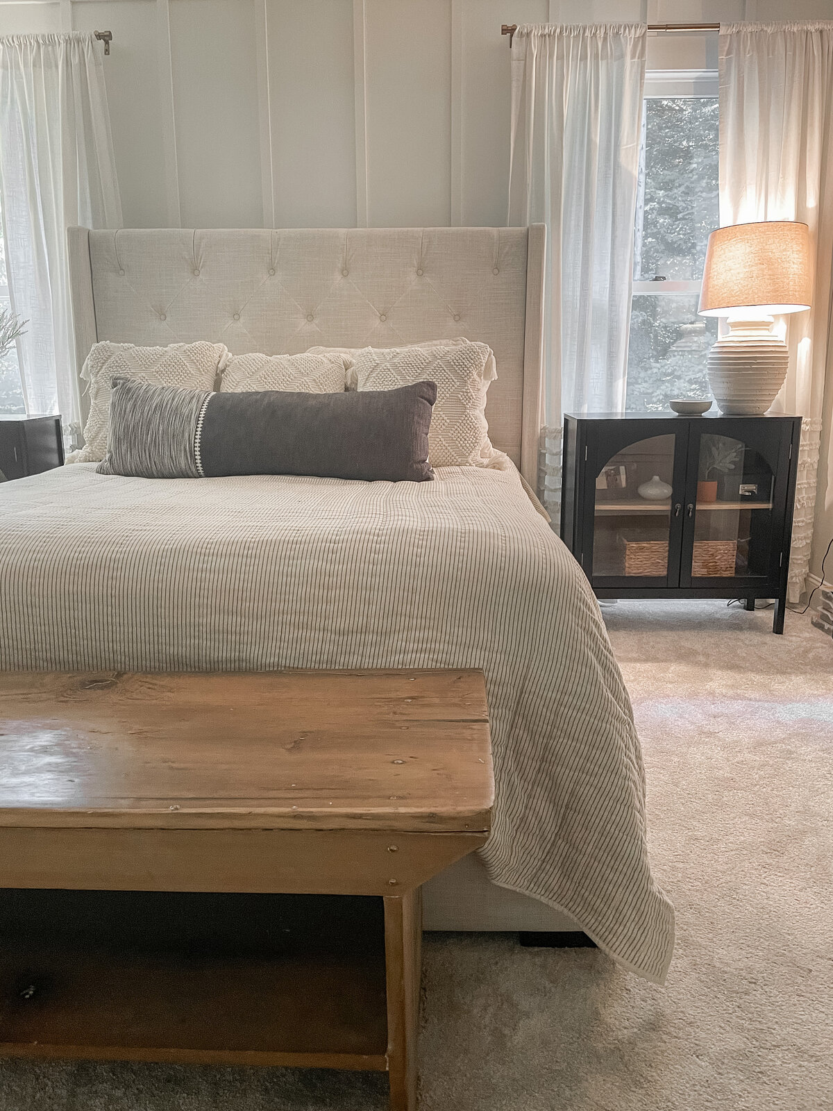 Modern farmouse accent wall in master bathroom with antique farmhouse bench