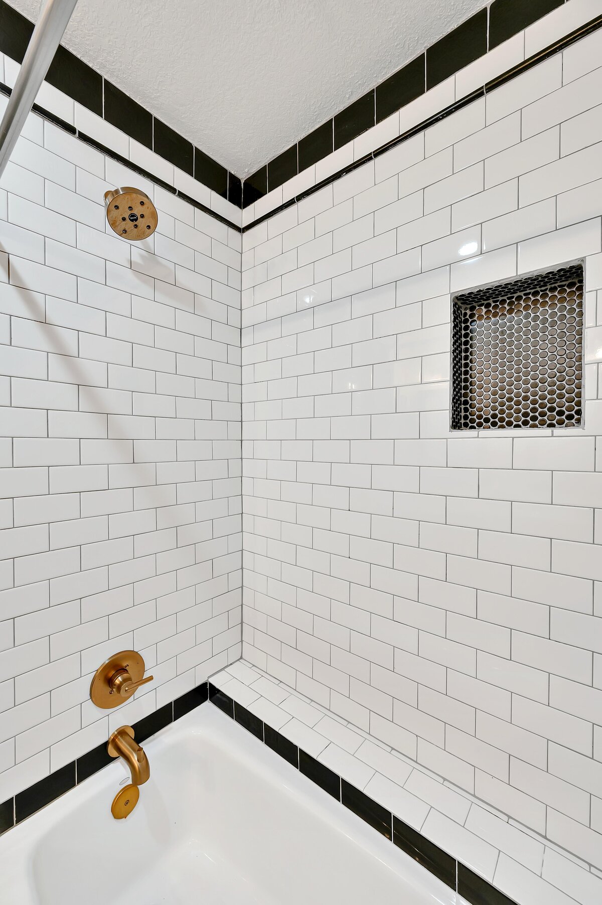 Tub/shower combo in the bathroom of this two-bedroom, two-bathroom vacation rental condo in the historic Behrens building in the heart of the Magnolia Silo District in downtown Waco, TX.