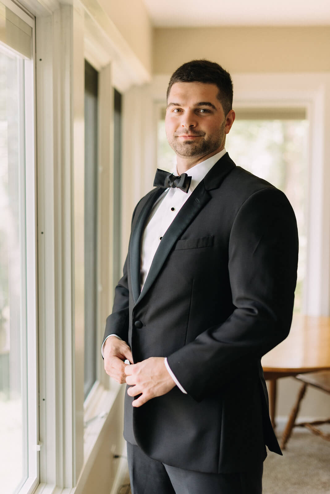 Groom wearing black tuxedo at Canandaigua Country Club wedding, NY