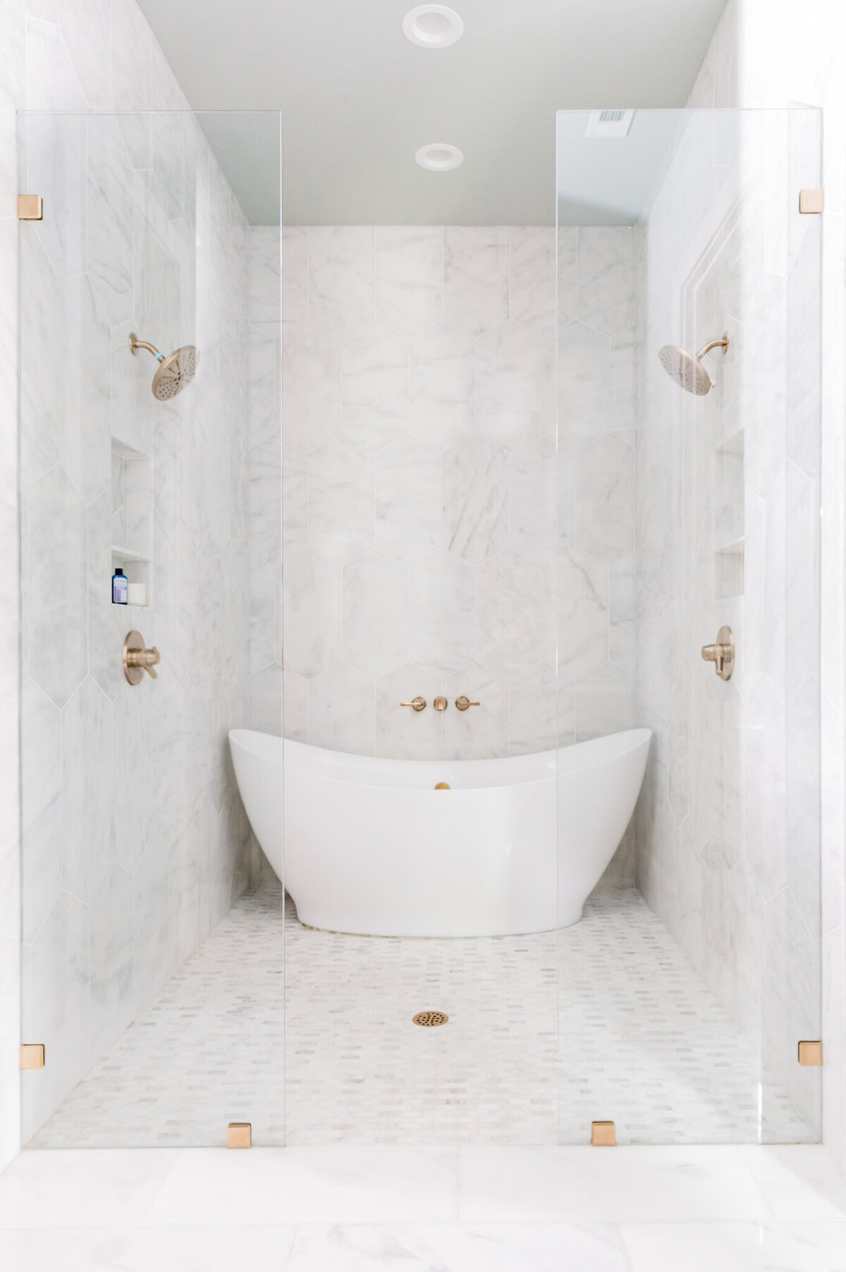 Shower room with tub and dual shower heads in a luxury home in Dallas