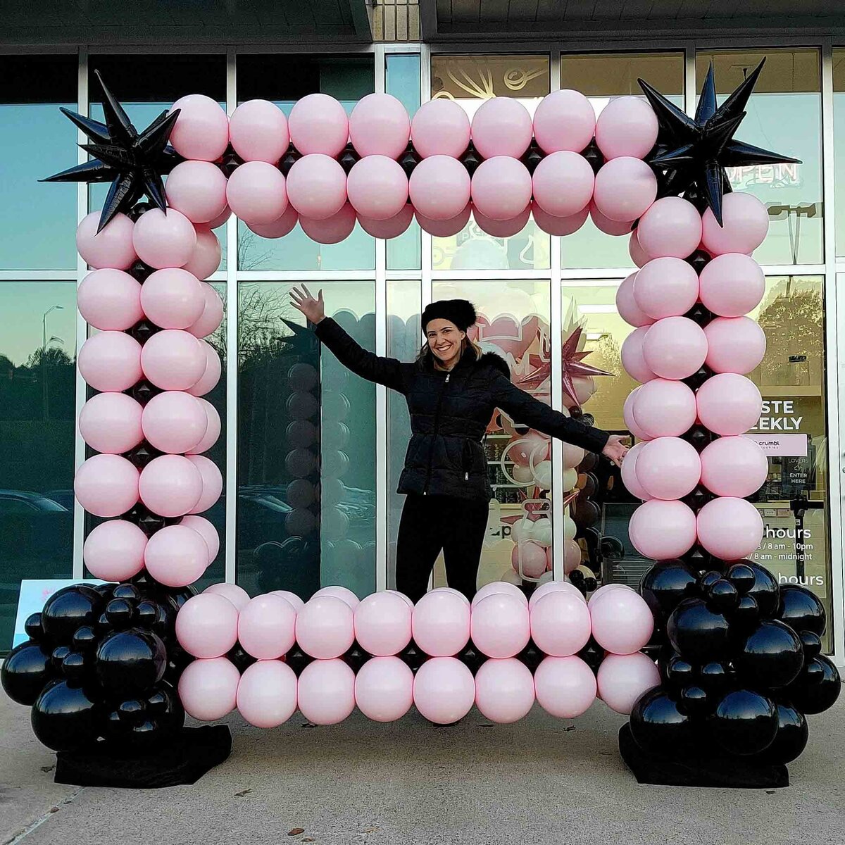 The celebration with air with flair decor custom balloon installation, featuring the chic design of black and pink square vibes.
