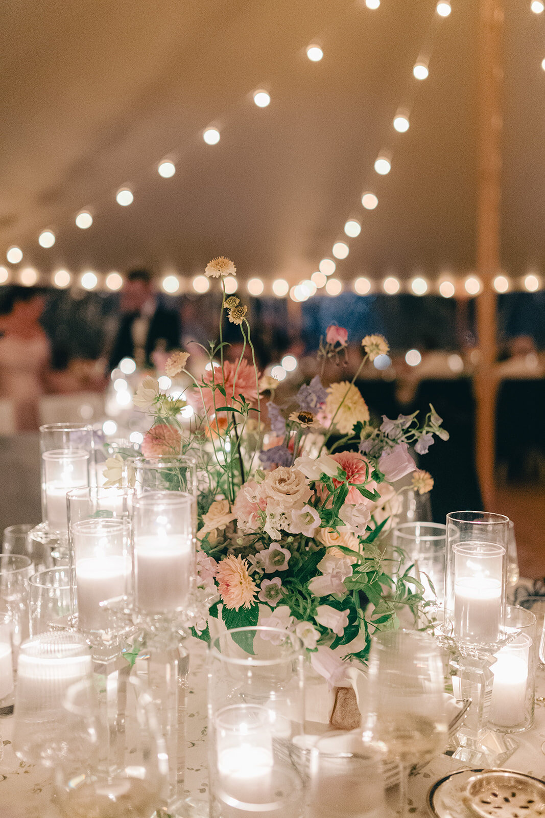 Large pastel centerpieces of lush flowers for a wedding reception at the Forest and Stream Club.