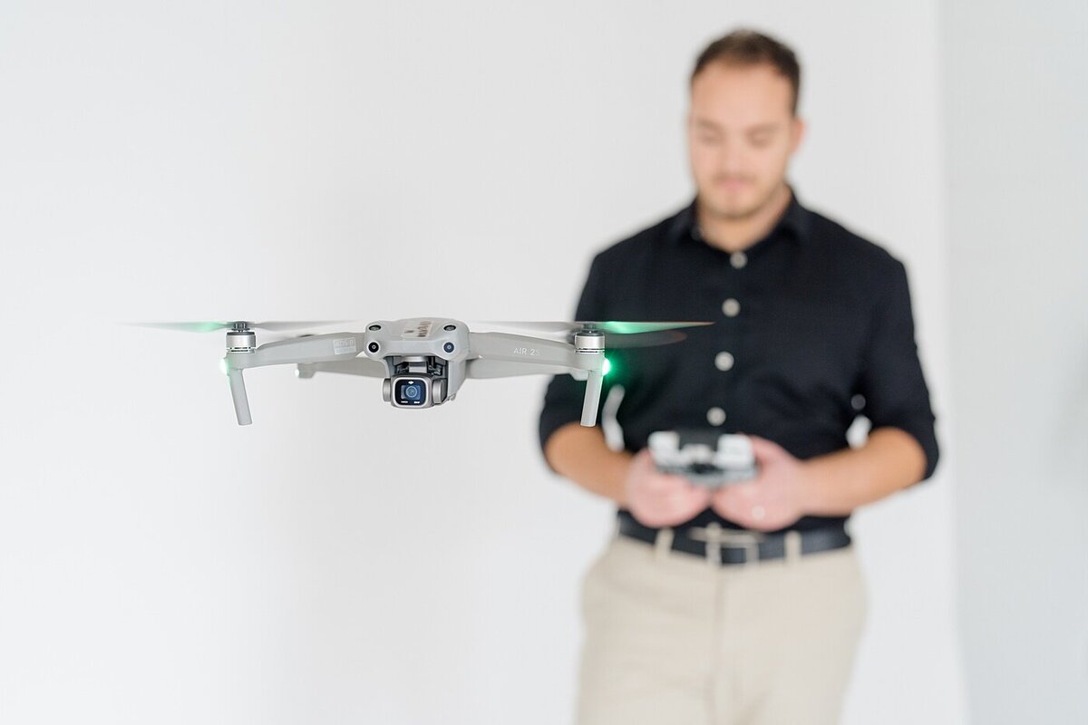 Columbus photographer photographs man using a remote to direct a drone for his tech business branding photos