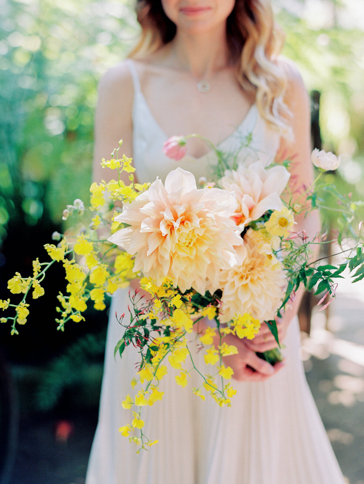 close up of a giant pink daliah in bridal bouquet