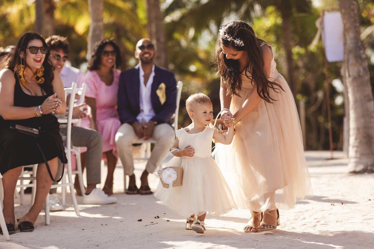 Flower girls walking down aisle at wedding in Riviera Maya