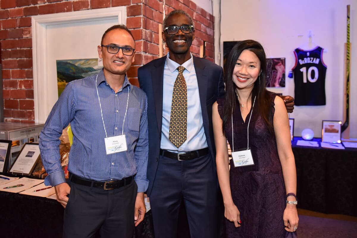 Three colleagues enjoying casual networking moments at a Toronto corporate event, captured by an event photographer