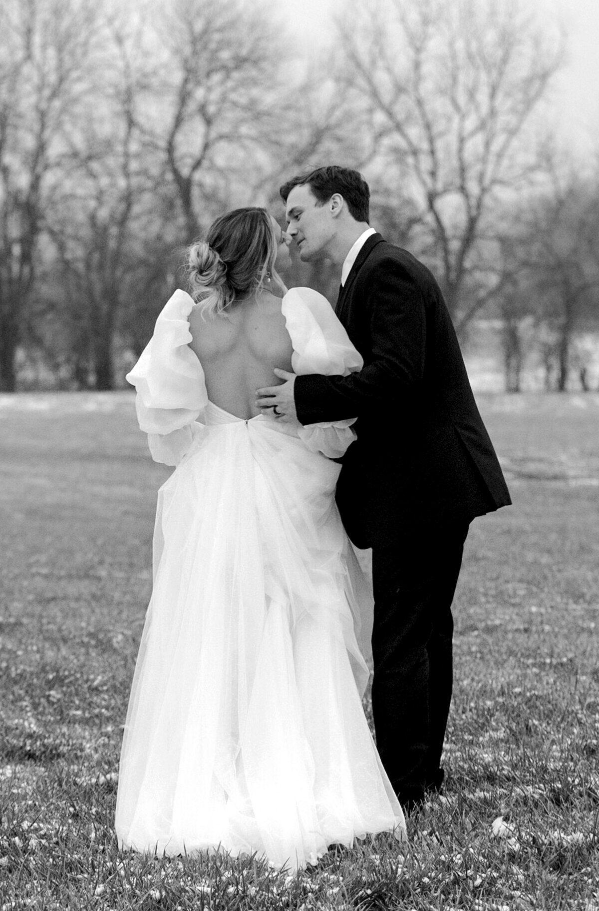 bride with groom in snow wearing an beautiful open back dress