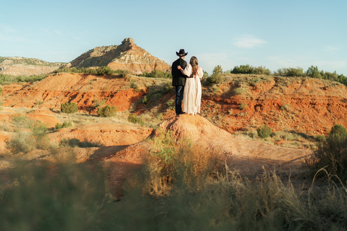 couple standing on a rock formation